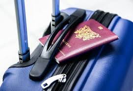 Business travel in Ghana – international passport and blue suitcase symbolizing travel readiness and corporate mobility.
