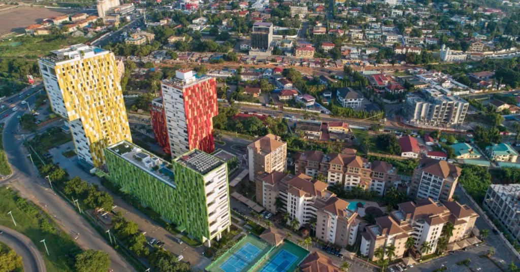 Aerial view of the modern, colorful Villaggio Vista luxury apartment complexes in Accra, showcasing premium residential options available through expatriate relocation services in Ghana.